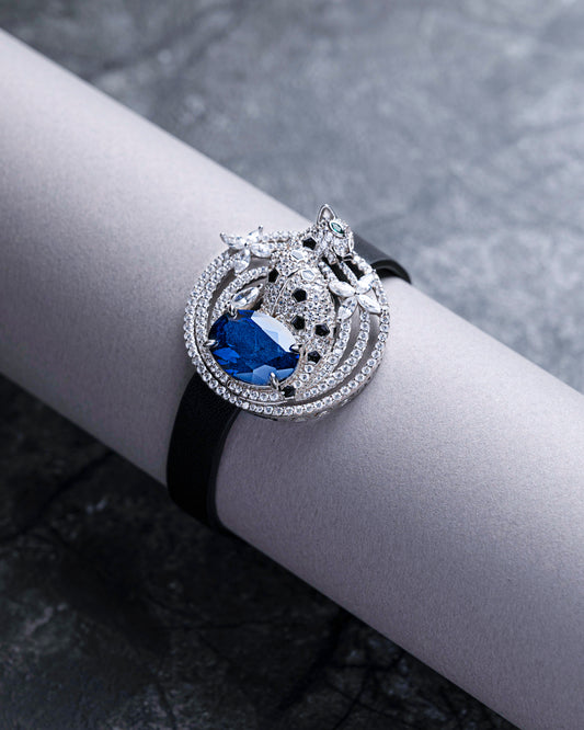 BRACELET STUDDED WITH BLUE CZ TIED IN A LEATHER STRAP