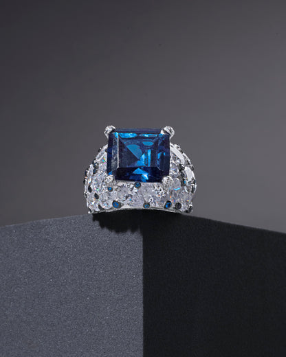 RING STUDDED WITH ICE CUT BLUE CZ