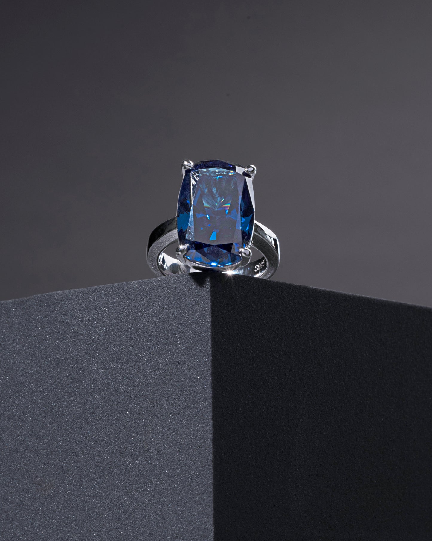 RING STUDDED WITH FAR SIZE ICE CUT BLUE CZ