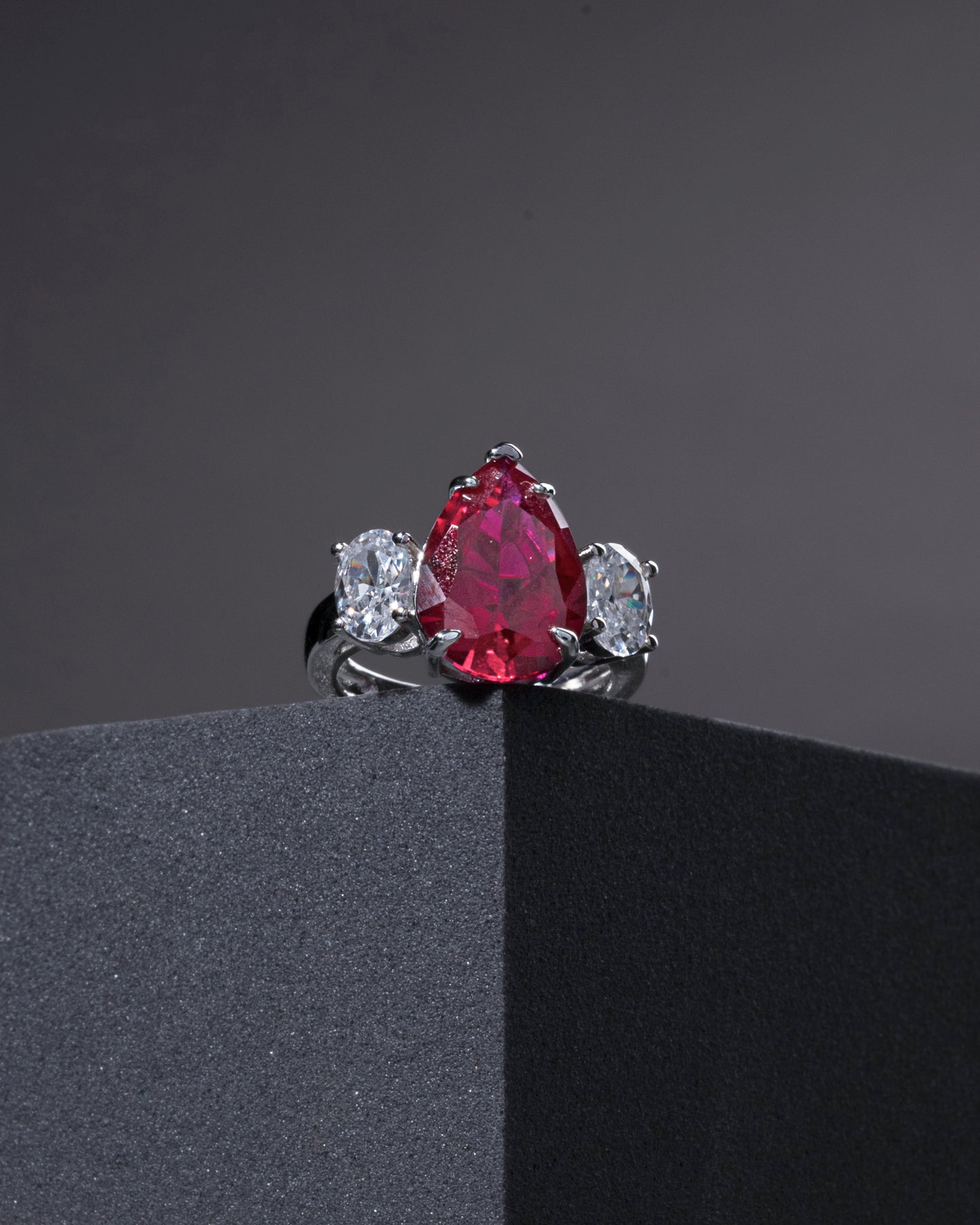 RING STUDDED WITH ICE CUT RED CZ