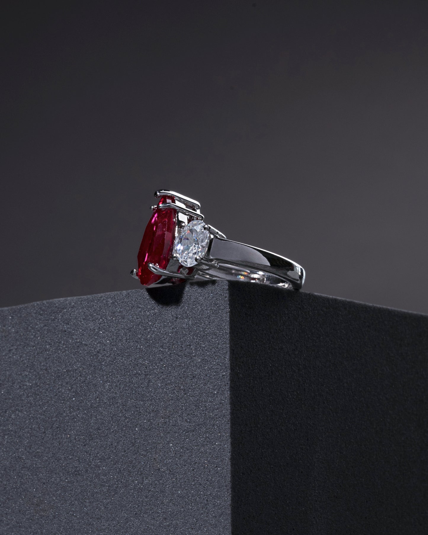 RING STUDDED WITH ICE CUT RED CZ